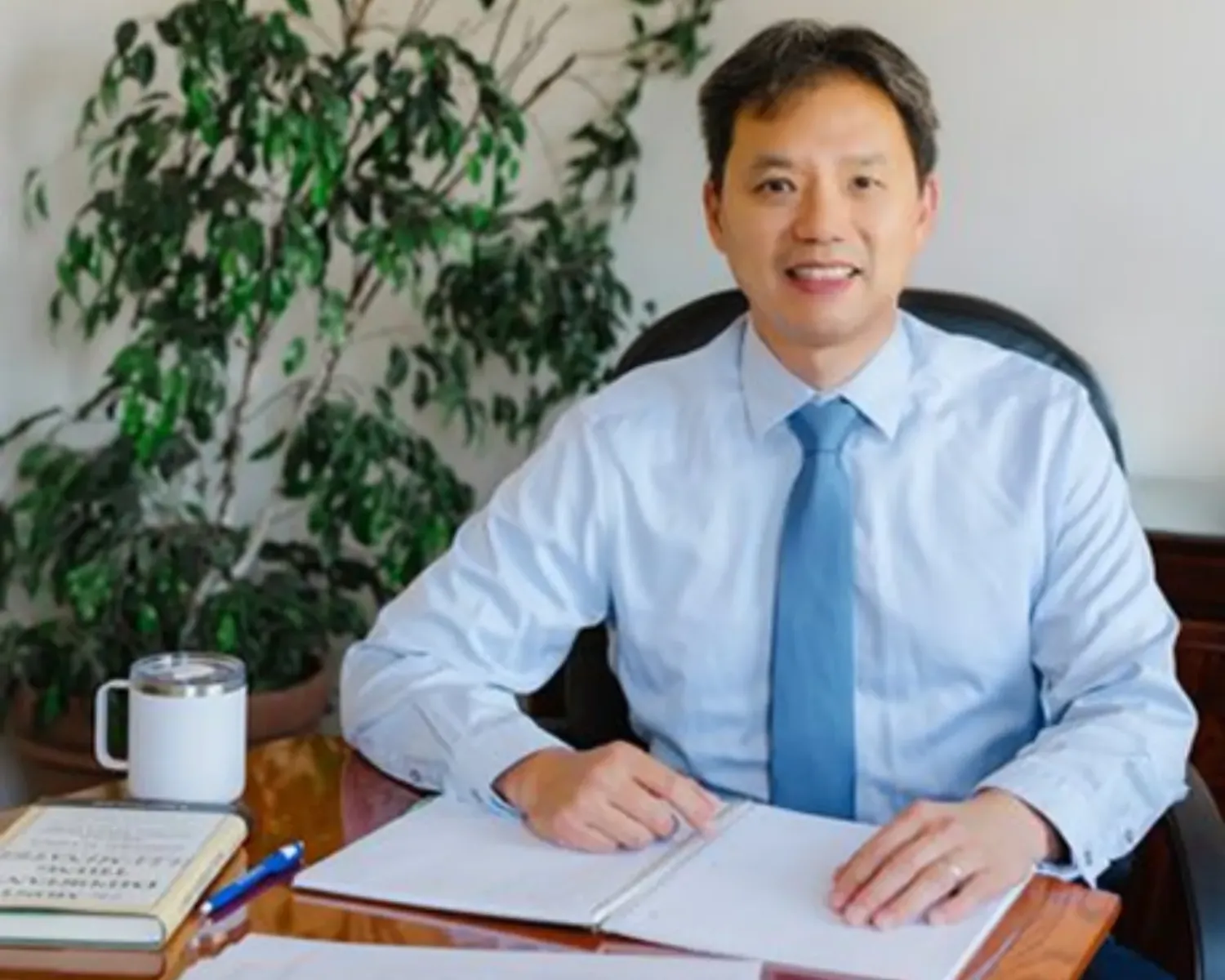 Earl sitting at a table with an open notebook.