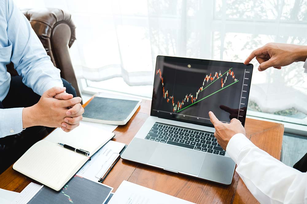 People watching investments on a laptop.