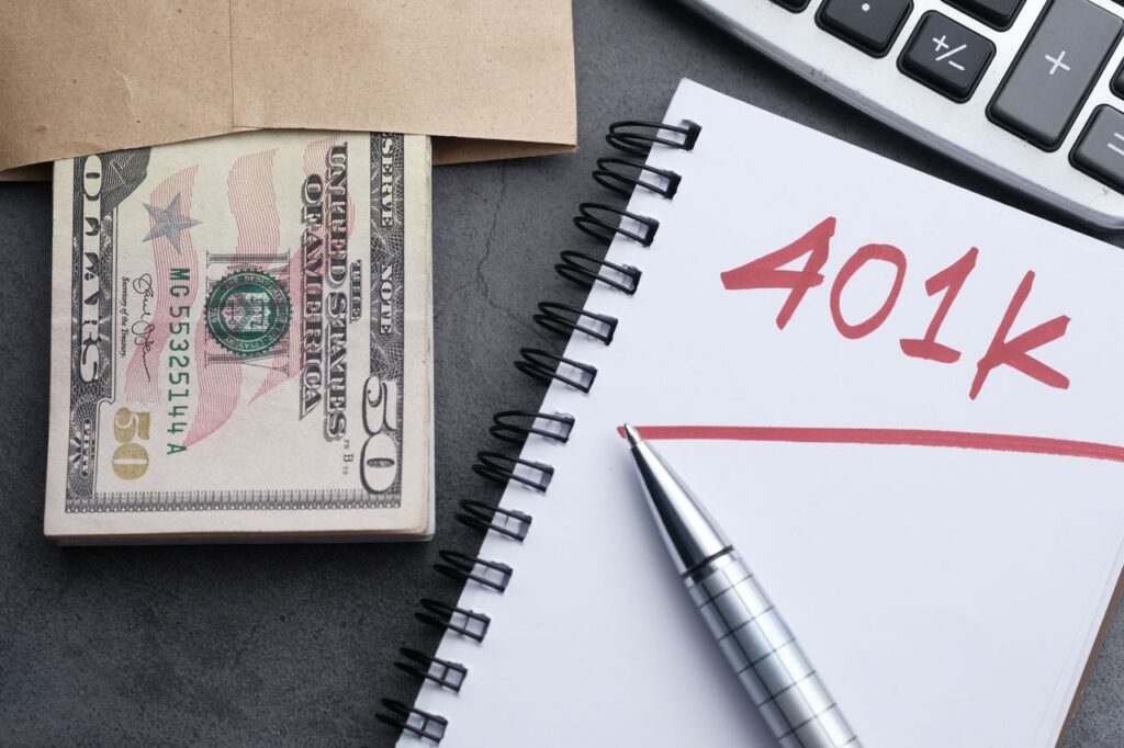 Money and a calculator next to a notepad
